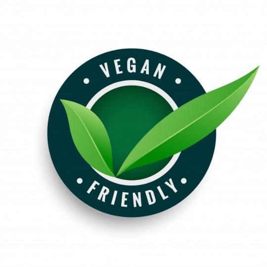 Vegan friendly leaves label in green color Free Vector