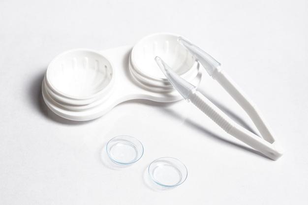 High angle of transparent contact lenses with case and tweezers Free Photo